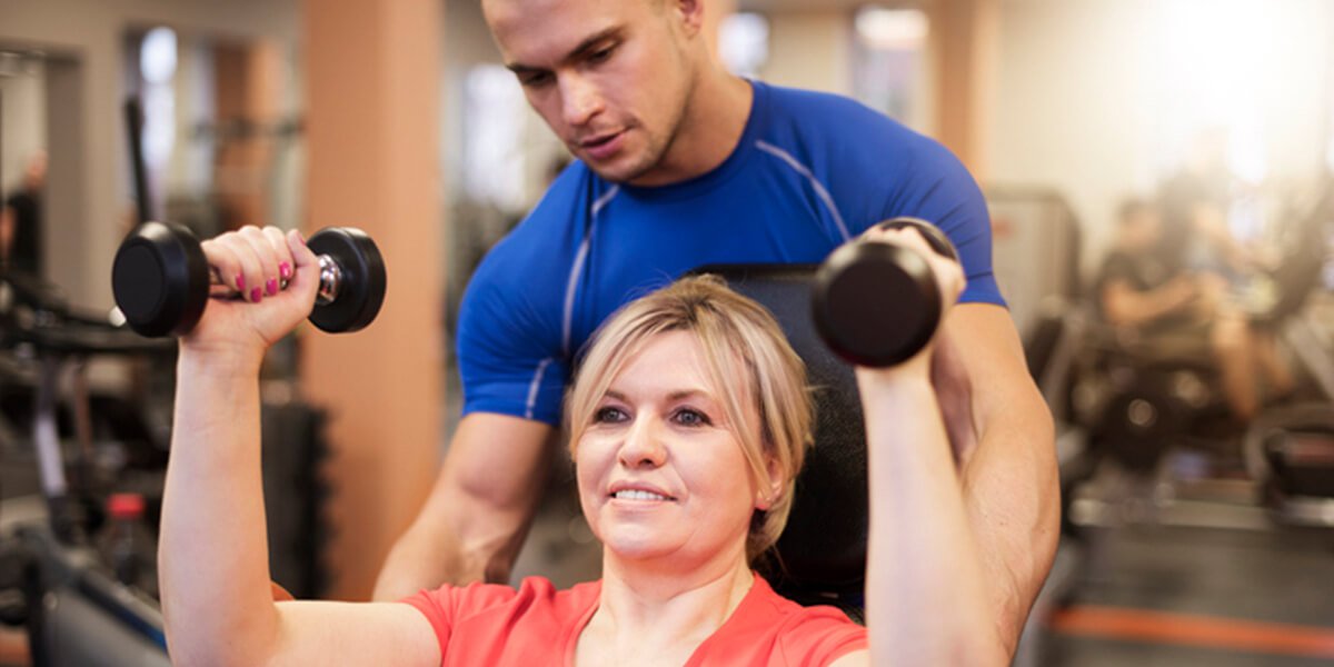 trainer workout with woman - best shoulder replacement surgeons in Portsmouth, New Hampshire