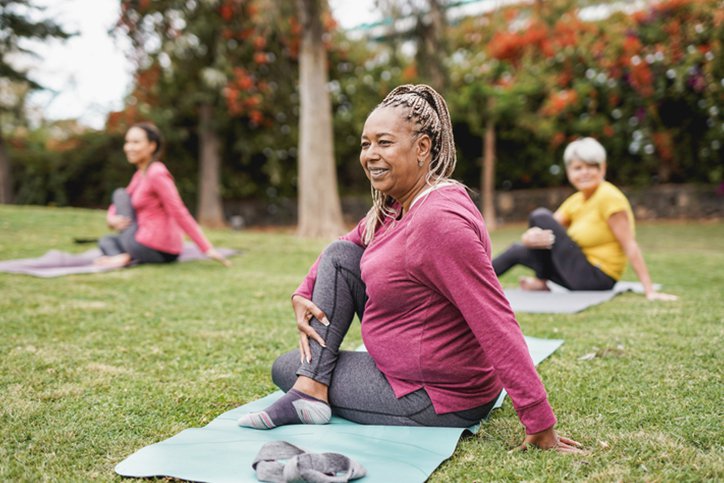 woman in park doing yoga - best knee hip replacement surgeons in New Hampshire